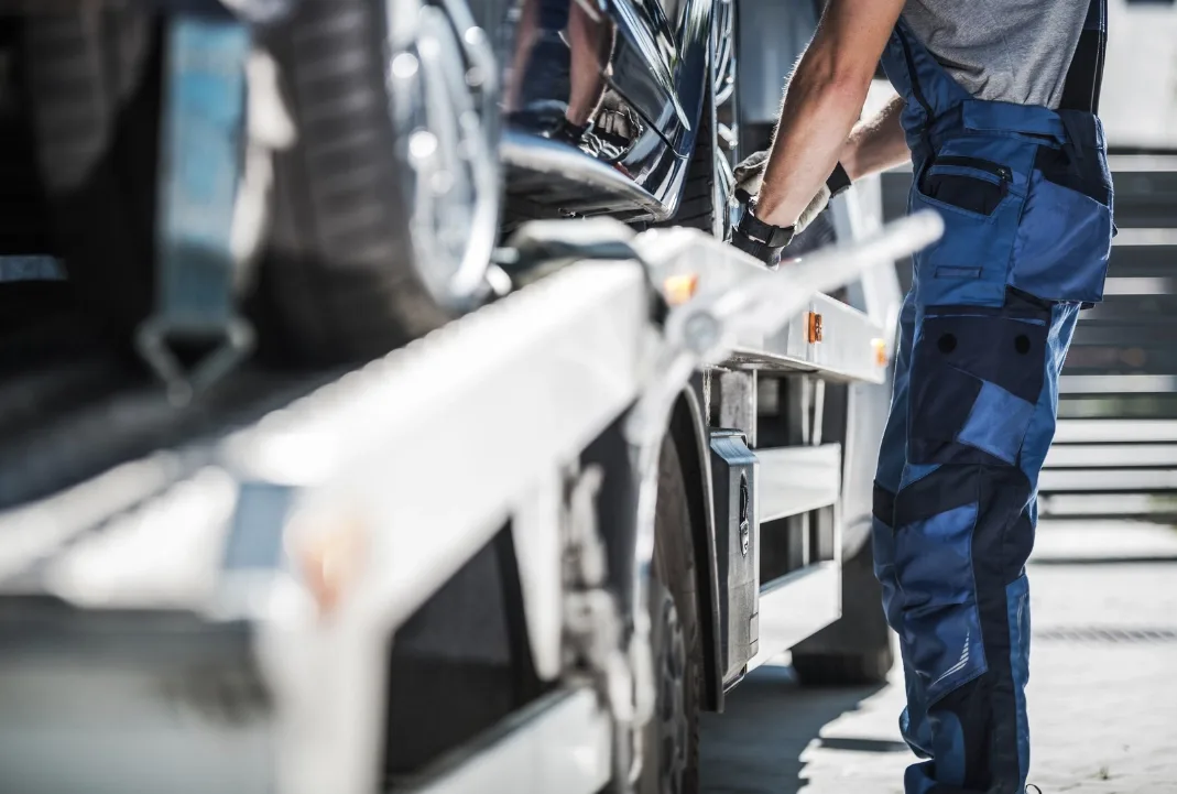 Mississauga tow truck driver loading a car onto a flatbed